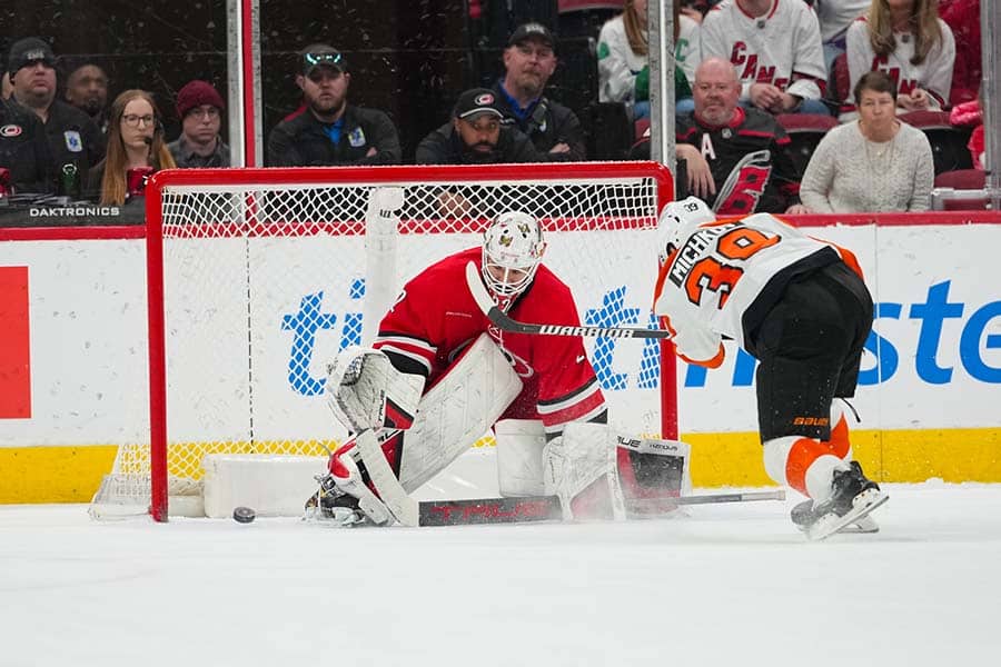 Dec 14, 2025; Raleigh, North Carolina, USA; Carolina Hurricanes goaltender Brandon Bussi (32) stops the shoot out attempt by Philadelphia Flyers right wing Matvei Michkov (39) at Lenovo Center.