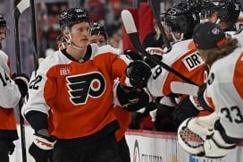 Dec 22, 2025; Philadelphia, Pennsylvania, USA; Philadelphia Flyers center Christian Dvorak (22) celebrates his goal with teammates against the Vancouver Canucks during the third period at Xfinity Mobile Arena.